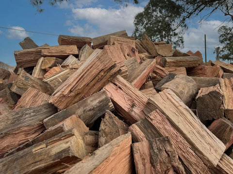 Mixed Hardwood Firewood - Half A Cube stacked ready for burning in a cozy fireplace.